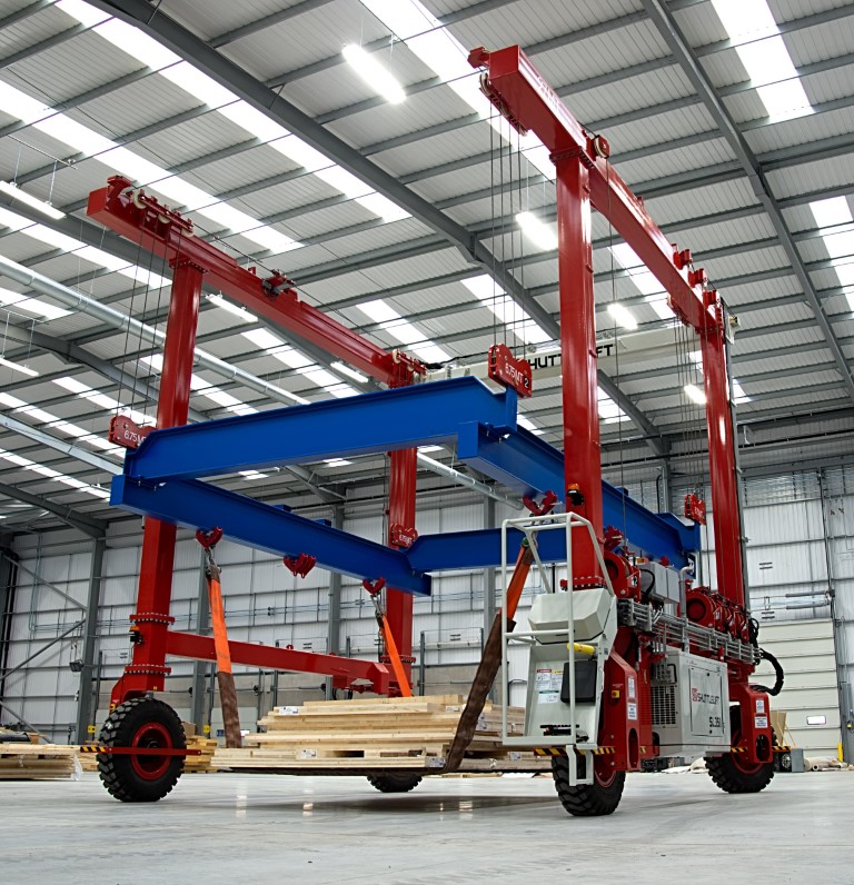 A Shuttlelift SL75II mobile gantry crane picks material in a warehouse
